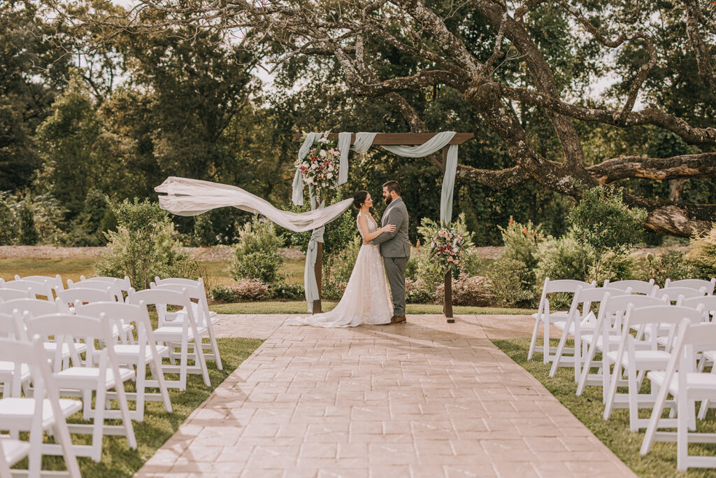 bride and groom photo at the wedding arch