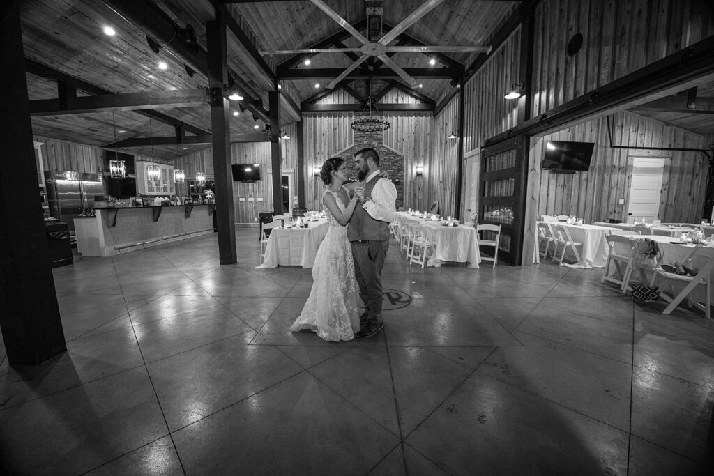 bride and groom sharing a dance in an empty reception hall at The Venue at Whiskey Ridge