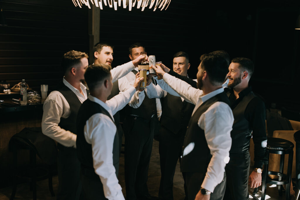 groom and groomsmen hanging out at the speakeasy style groom suite 