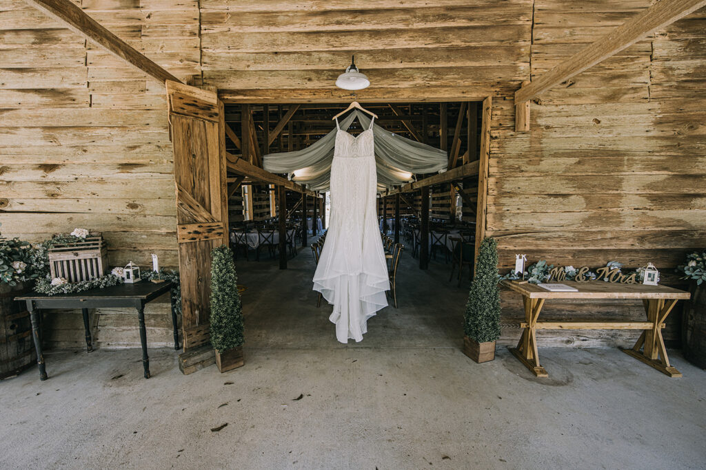 wedding dress hanging at the rustic wedding venue