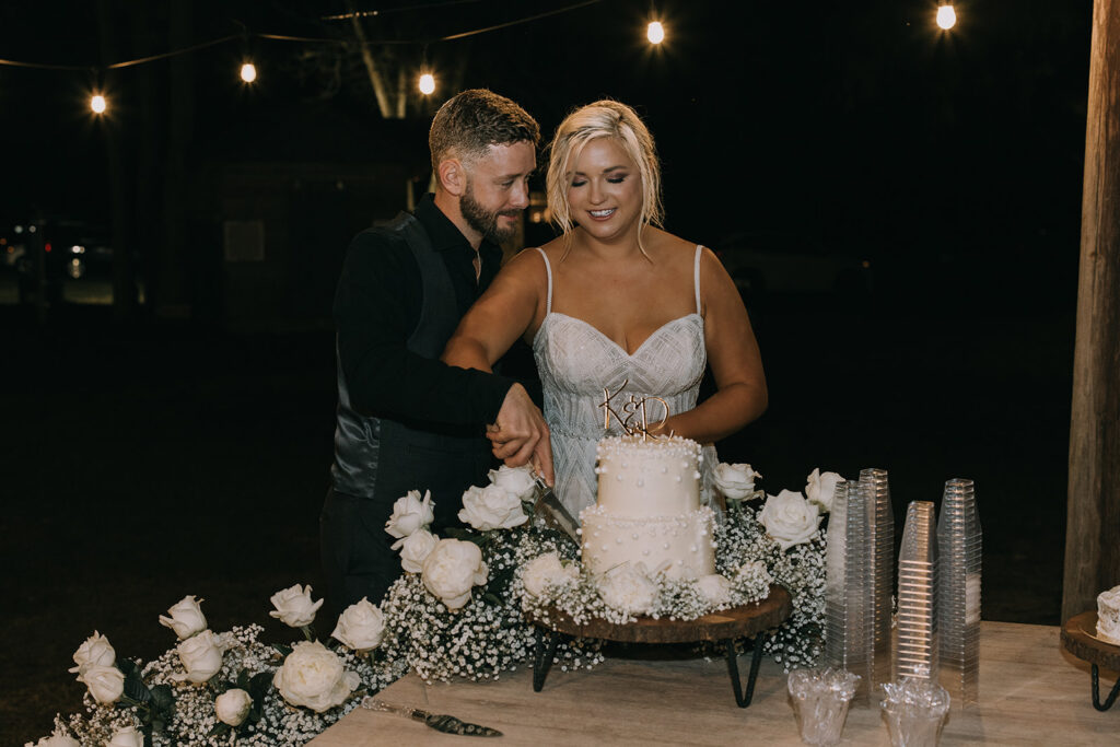 bride and groom cutting cake