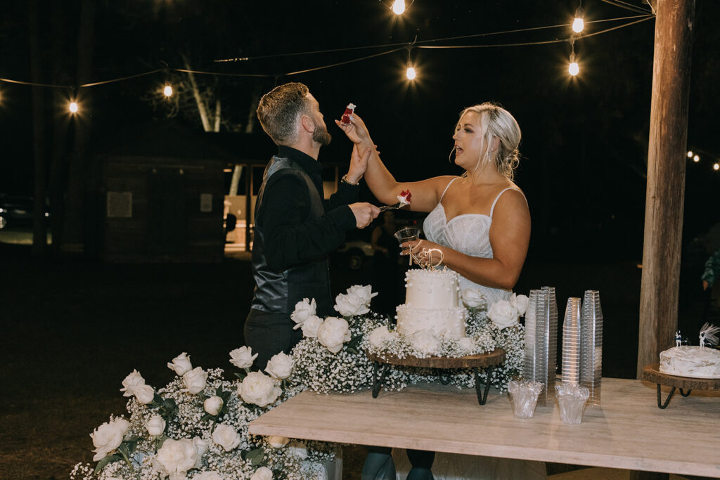 bride and groom cutting cake