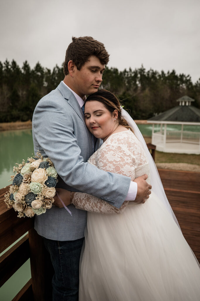 bride and groom posing at the pond at Sowell Farms in Milton, FL