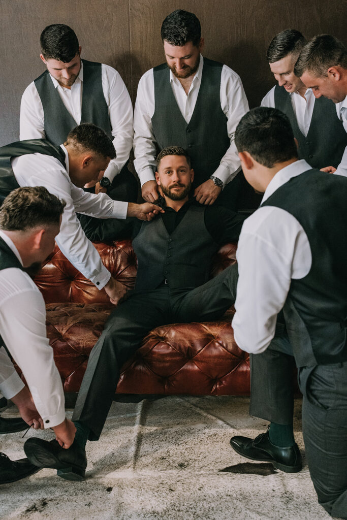 groom and groomsmen at the speakeasy style groom suite at the woodberry