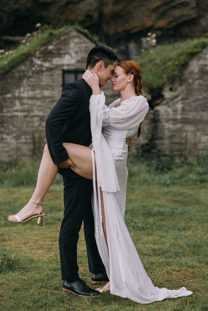 romantic bride and groom surrounded by lush landscapes of Iceland near Skogafoss