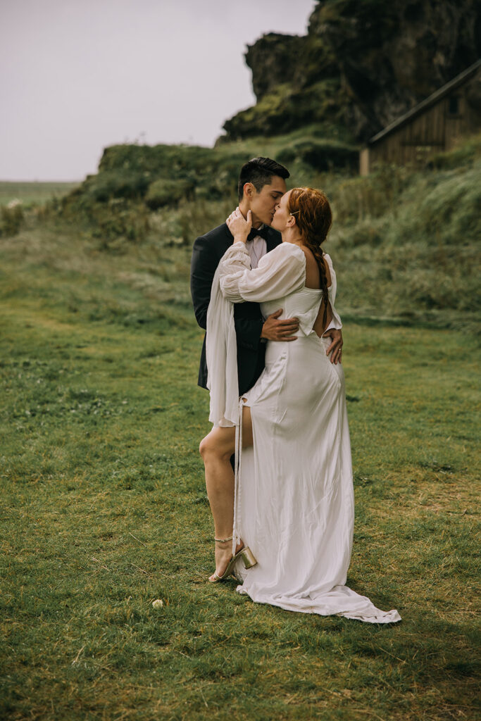 romantic bride and groom surrounded by lush landscapes of Iceland near Skogafoss