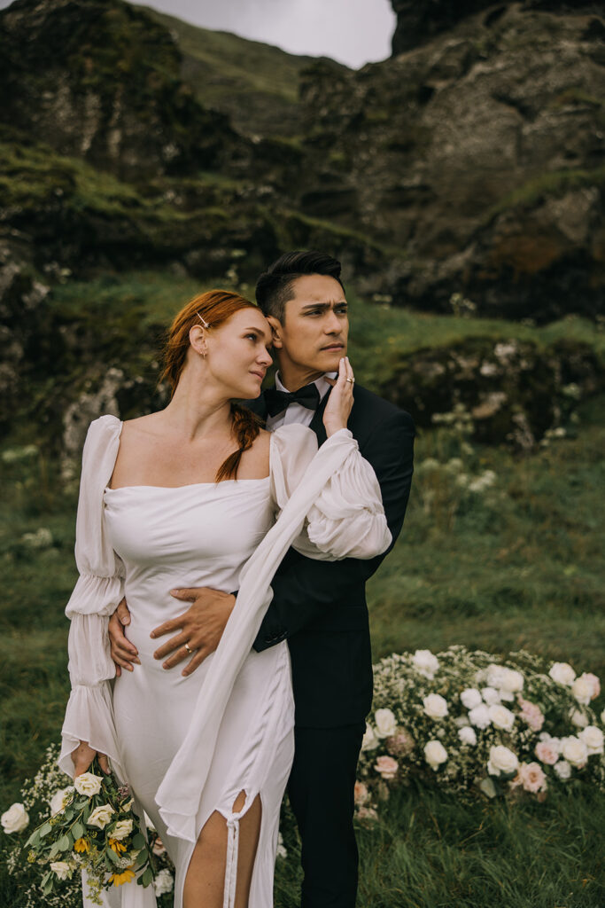 romantic bride and groom surrounded by lush landscapes of Iceland near Skogafoss