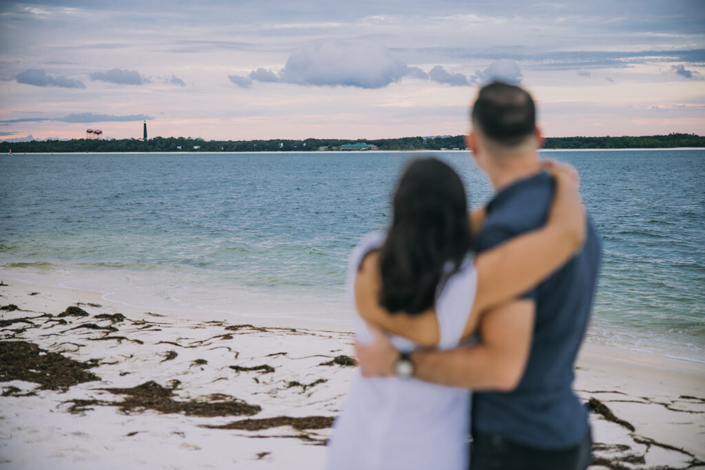 a couple posing by the sea shore