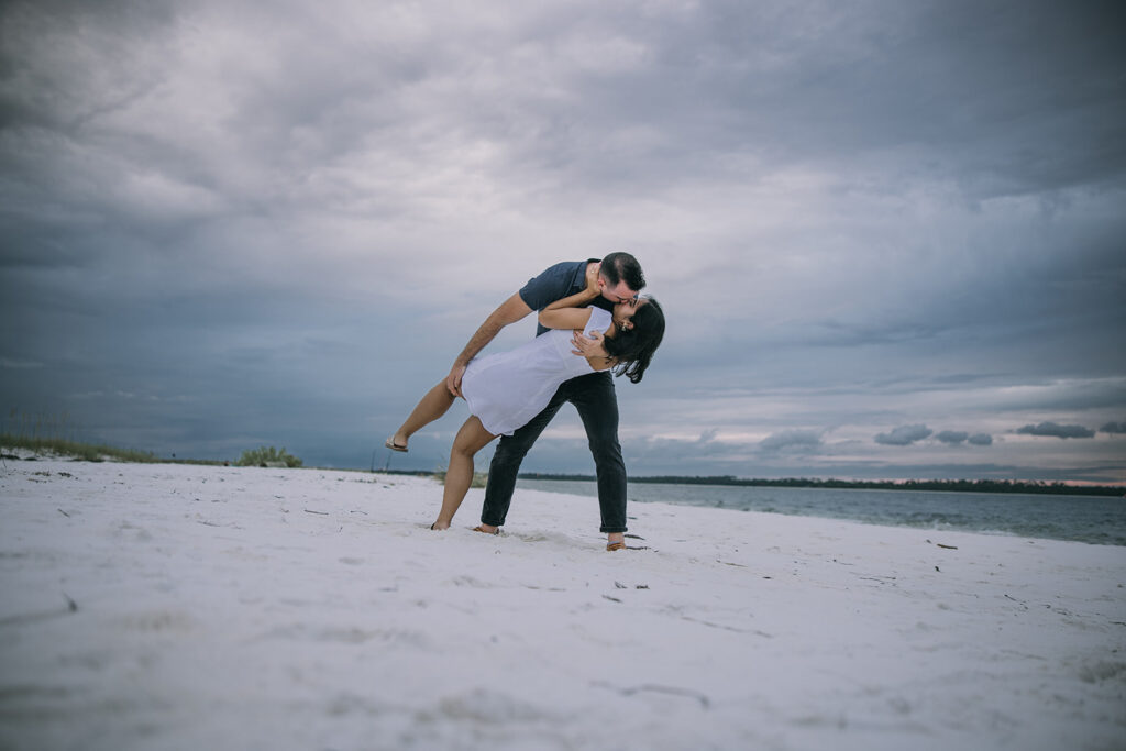 a couple posing by the sea shore