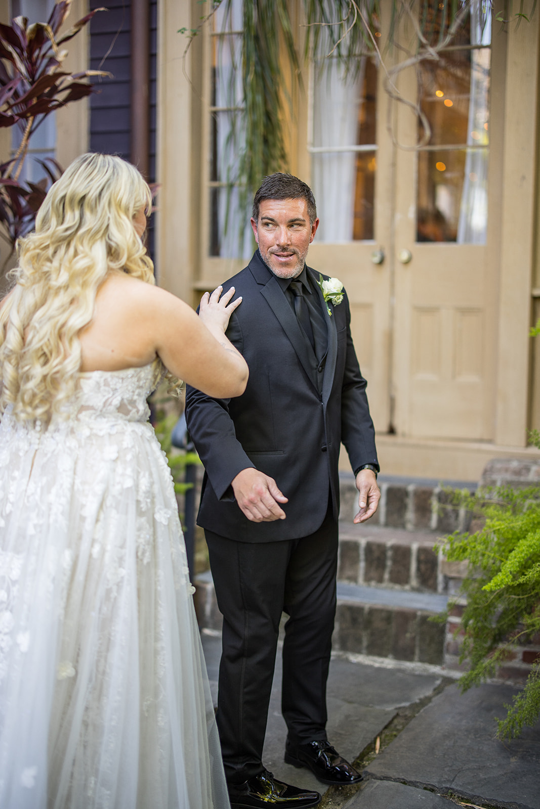 Bride in her white dress approaches her groom for their first look at the Seraphim House in New Orleans, Louisiana. 