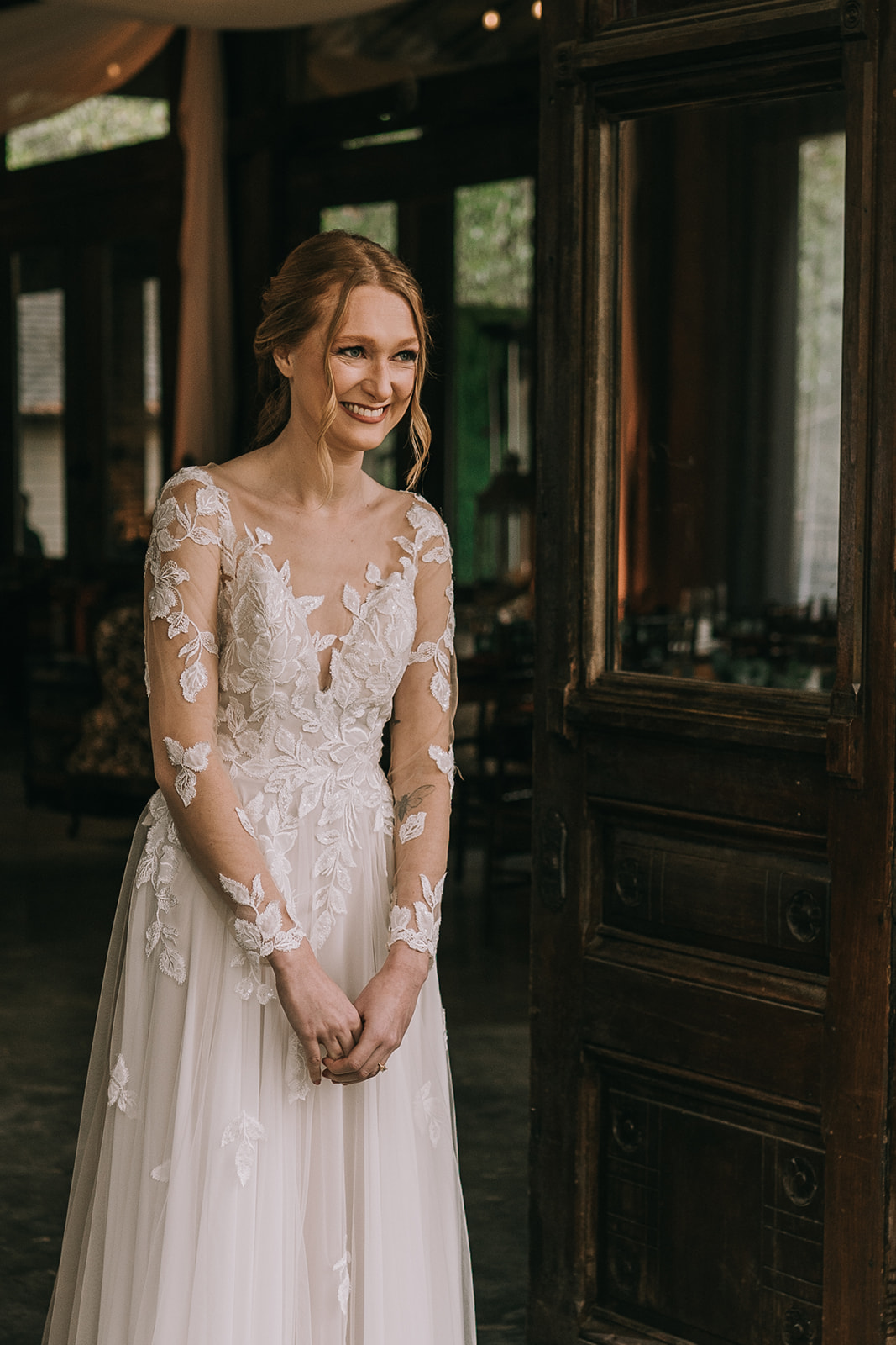 Reaction of a bride in her white dress as her father sees her for the first time on her wedding day in Pensacola, Florida.