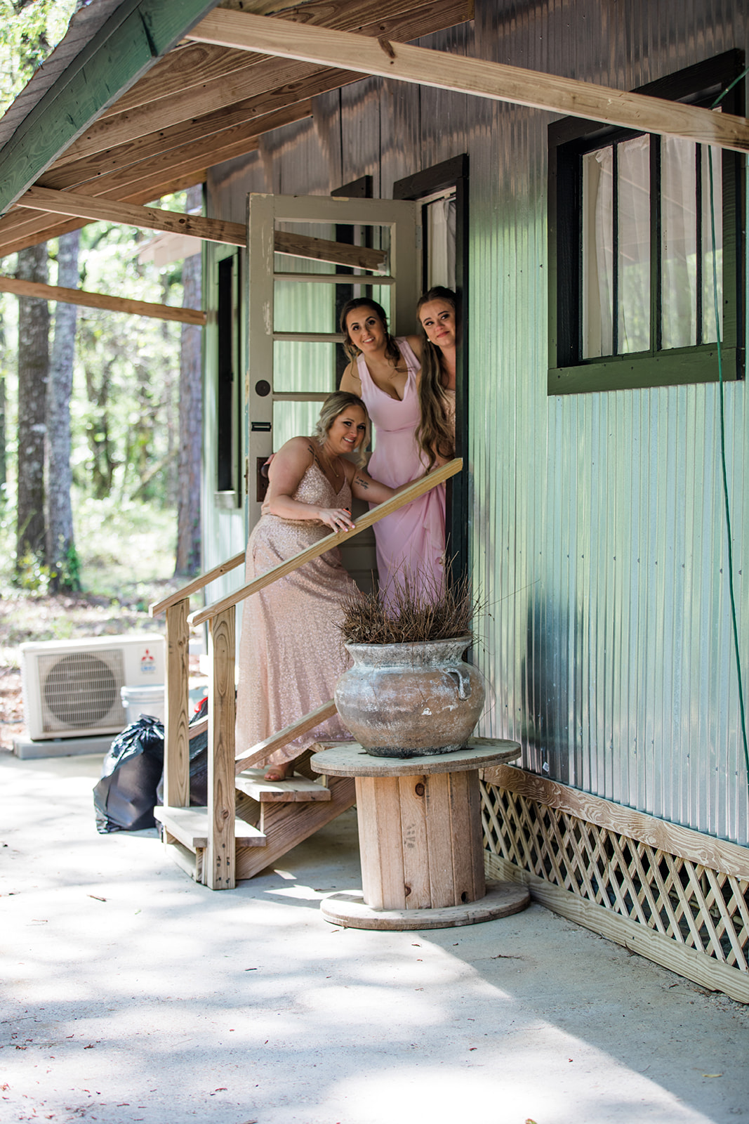 Bridesmaids, in their dresses look on as the bride and groom have their first look.