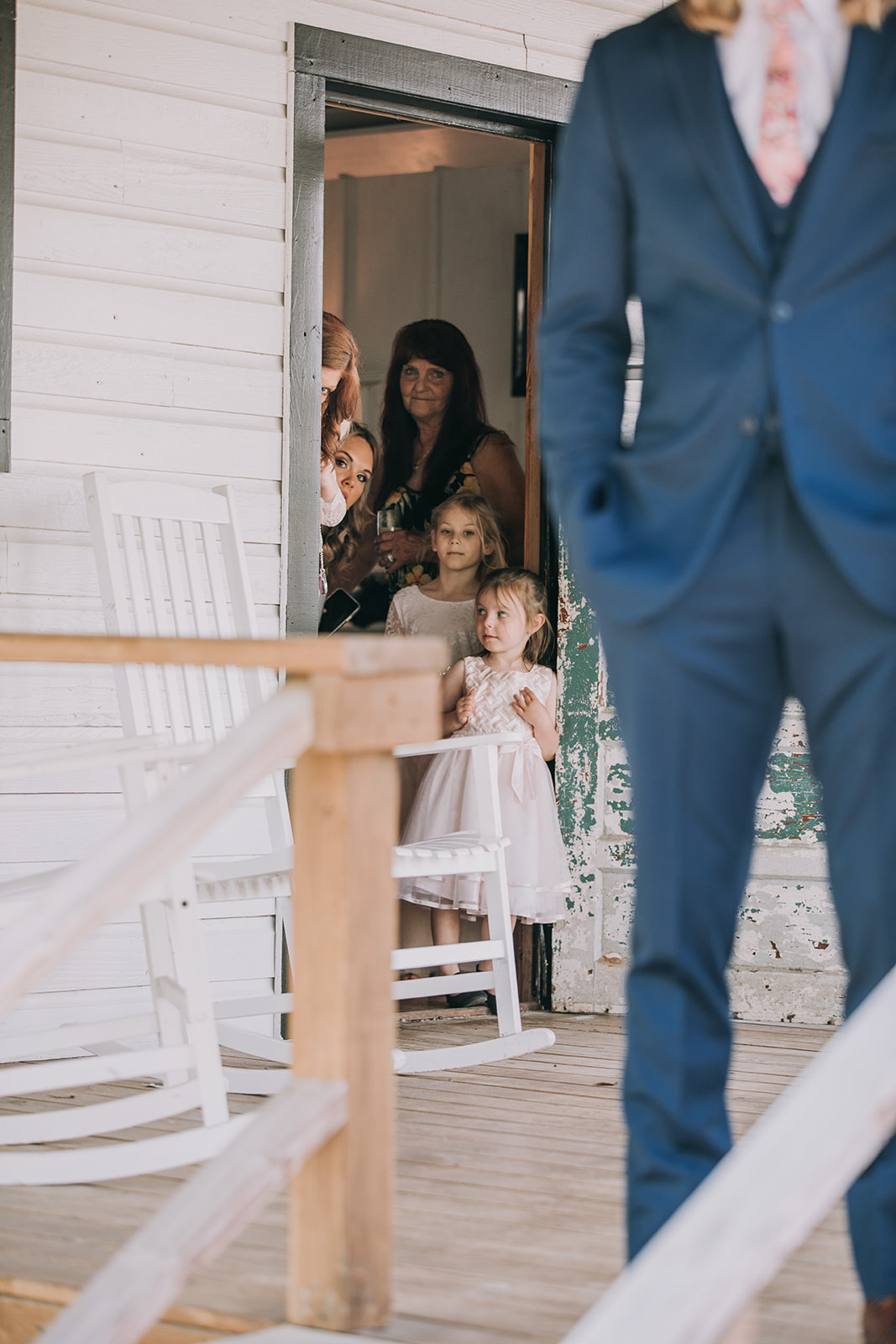 Family members try to watch on as the bride and groom have their first look.