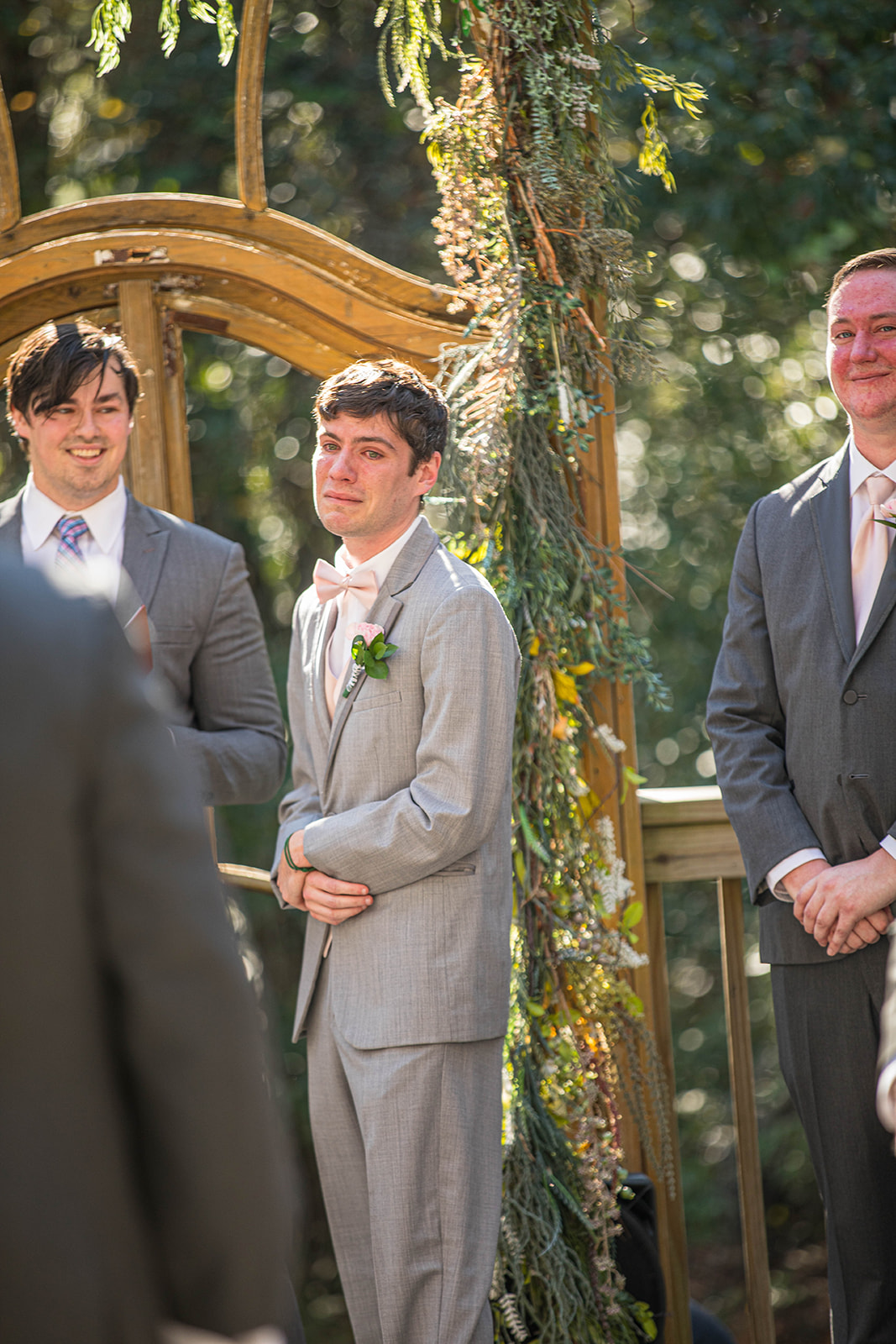 Groom becomes emotional seeing his bride for the first time as she walks down the aisle at Bela Sera Gardens in Loxley, Alabama