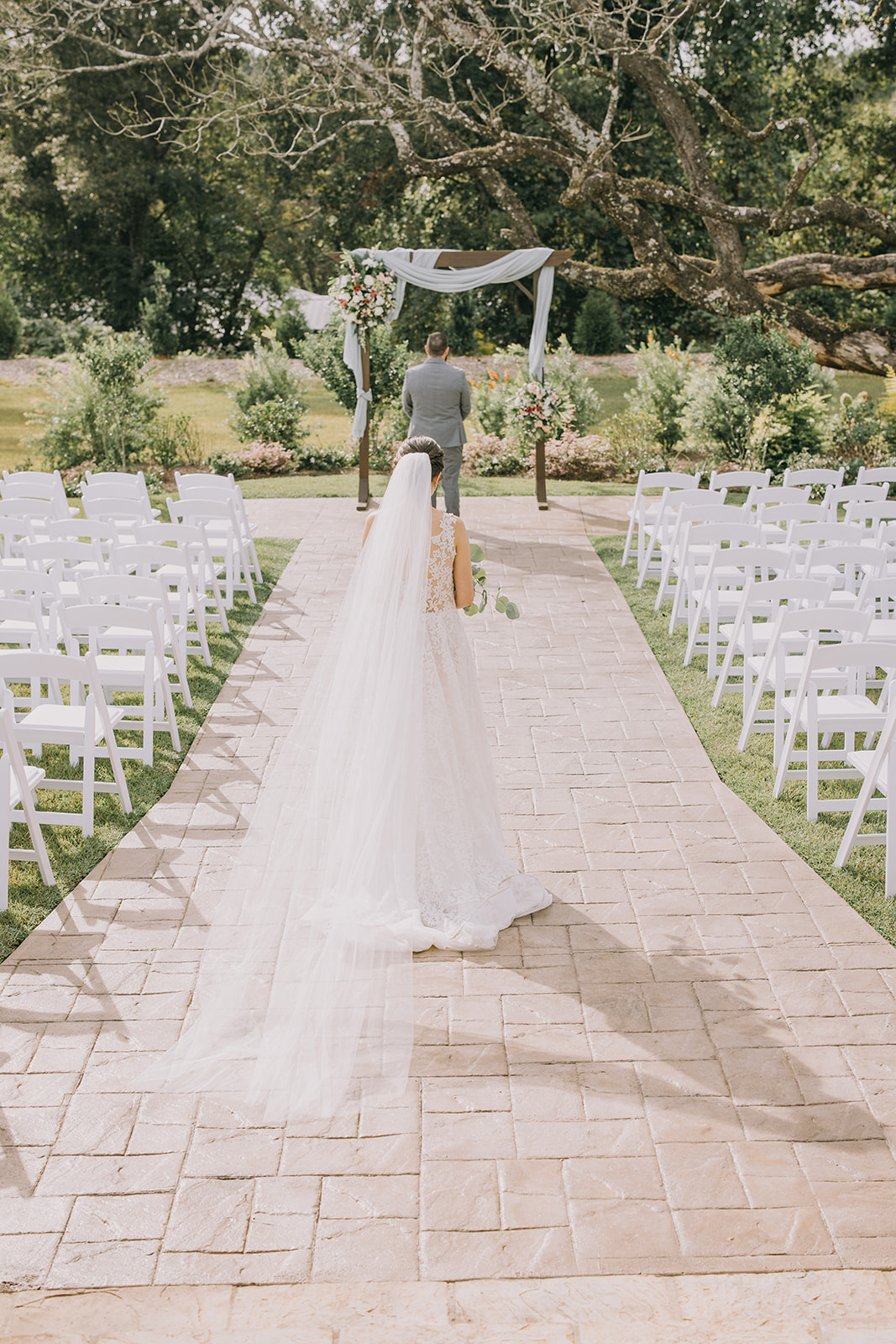 Bride in her white wedding dress approaching her groom for their first look.